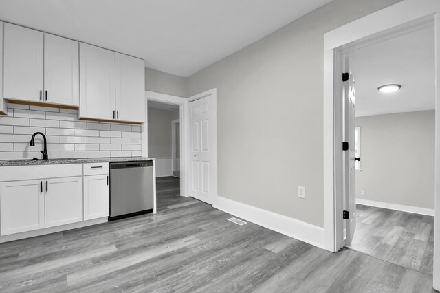 44 W 4th St, Fredericktown, OH 43019 - kitchen with dishwasher, a sink, light wood finished floors, white cabinets, and tasteful backsplash
