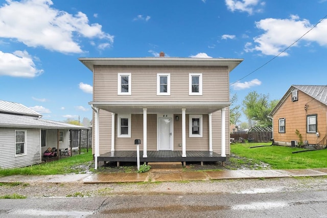44 W 4th St, Fredericktown, OH 43019 - view of front of property featuring covered porch and a front lawn