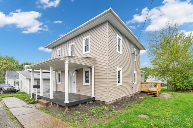 44 W 4th St, Fredericktown, OH 43019 - view of front facade featuring a front lawn and a wooden deck