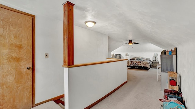 carpeted bedroom with a textured ceiling and vaulted ceiling