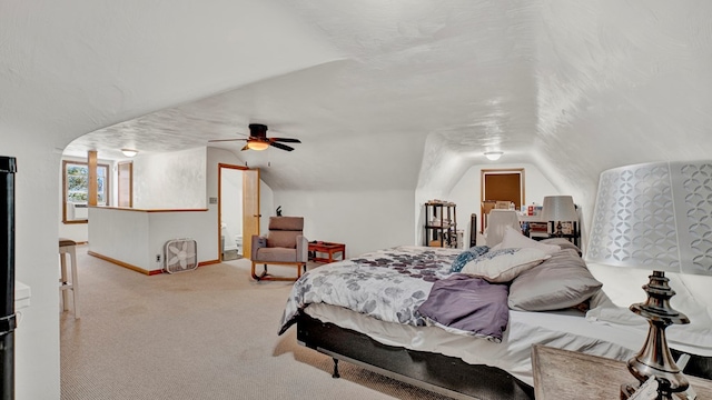 carpeted bedroom with a textured ceiling, vaulted ceiling, and ceiling fan