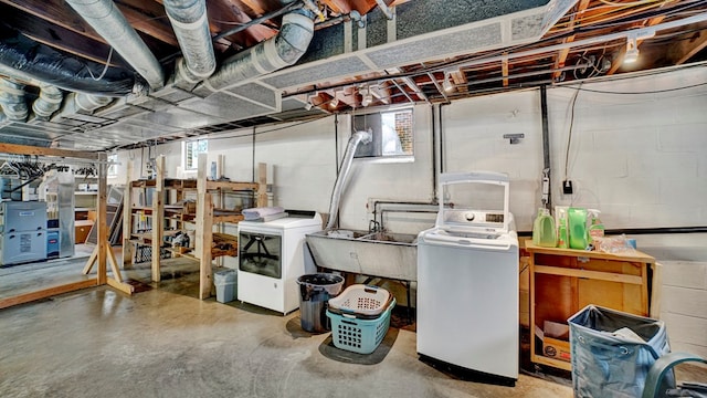 basement with washer / clothes dryer, sink, and a healthy amount of sunlight