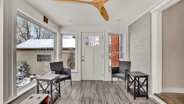 sunroom / solarium with ceiling fan and a healthy amount of sunlight