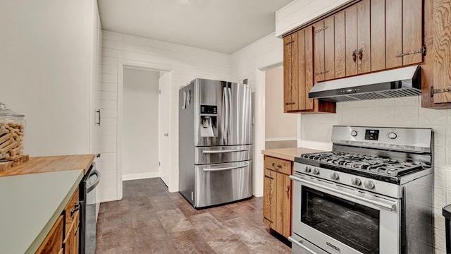 kitchen featuring decorative backsplash, stainless steel appliances, and extractor fan