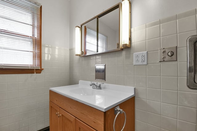 bathroom featuring vanity, tile walls, and a healthy amount of sunlight