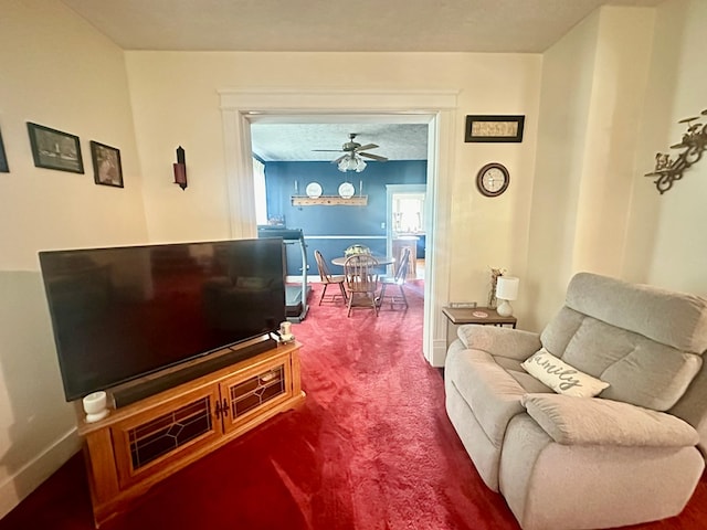 carpeted living room with ceiling fan