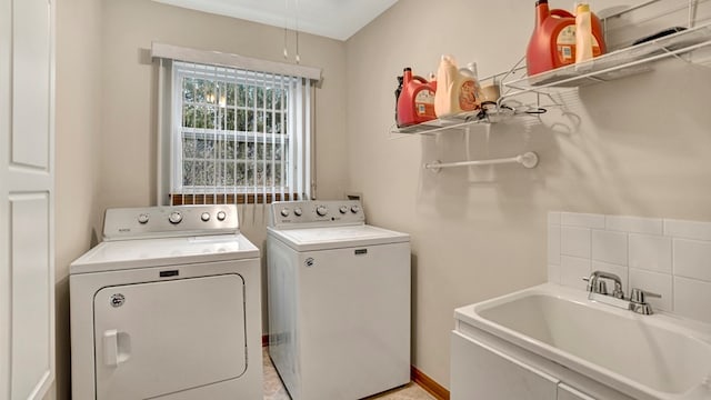 washroom with independent washer and dryer and sink