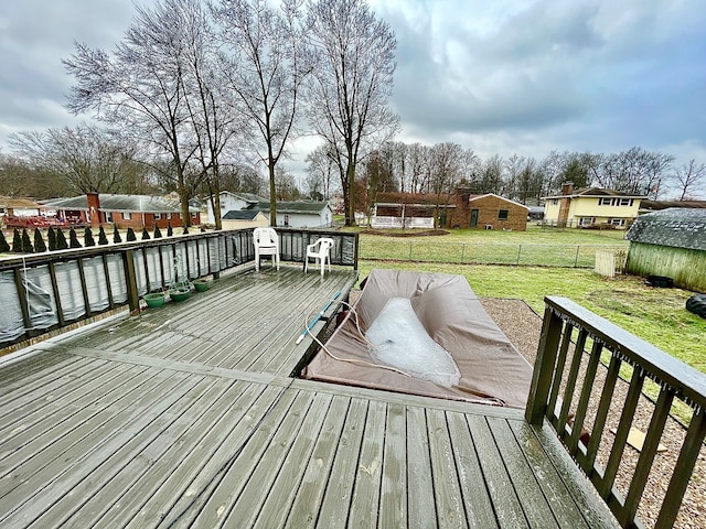 wooden deck featuring a yard