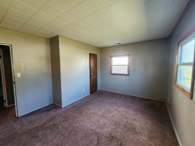 unfurnished bedroom featuring dark carpet