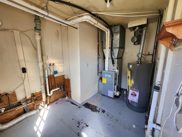 utility room featuring heating unit and gas water heater