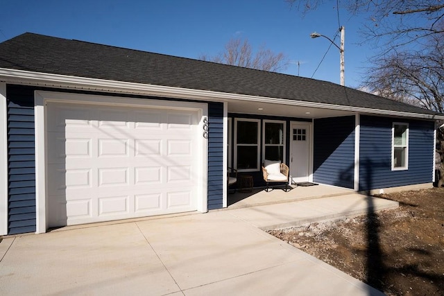 ranch-style home featuring covered porch, concrete driveway, roof with shingles, and an attached garage