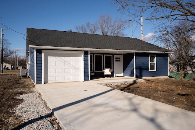 ranch-style home featuring a garage, concrete driveway, and a shingled roof