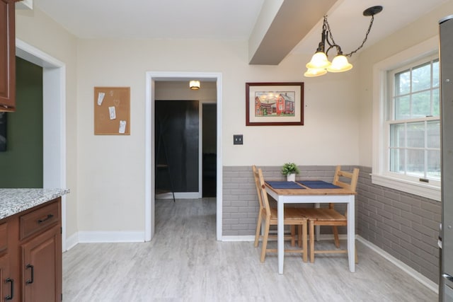 431 Overlook Rd, Mansfield, OH 44903 - dining room with light wood-type flooring, wainscoting, a chandelier, and brick wall