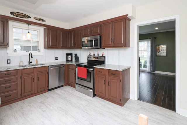 431 Overlook Rd, Mansfield, OH 44903 - kitchen with appliances with stainless steel finishes, light stone countertops, light wood-style flooring, and hanging light fixtures