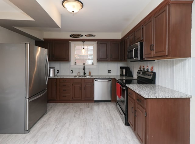 431 Overlook Rd, Mansfield, OH 44903 - kitchen featuring appliances with stainless steel finishes, light stone counters, and light wood-style flooring