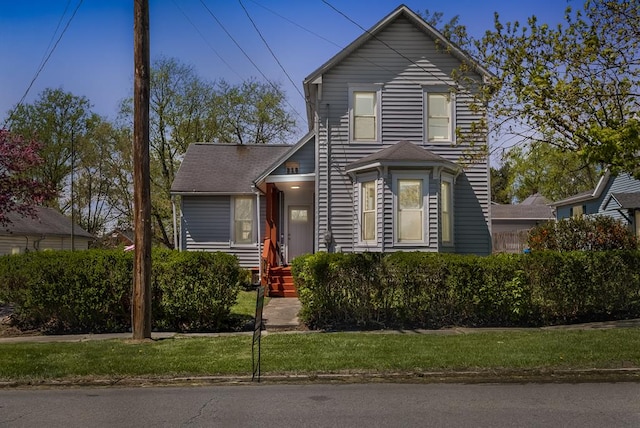 traditional-style home with a front lawn