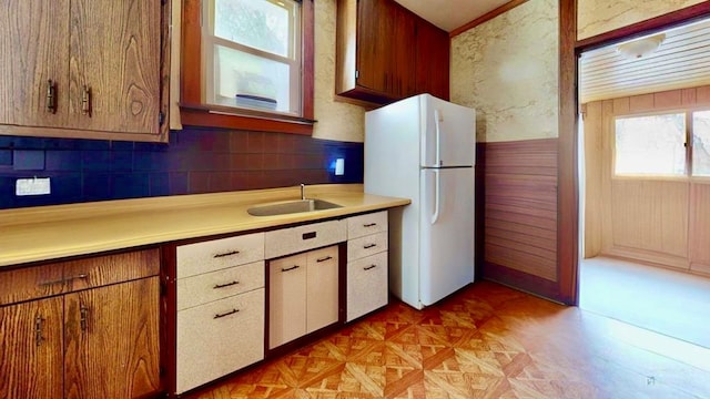 kitchen featuring white refrigerator and sink