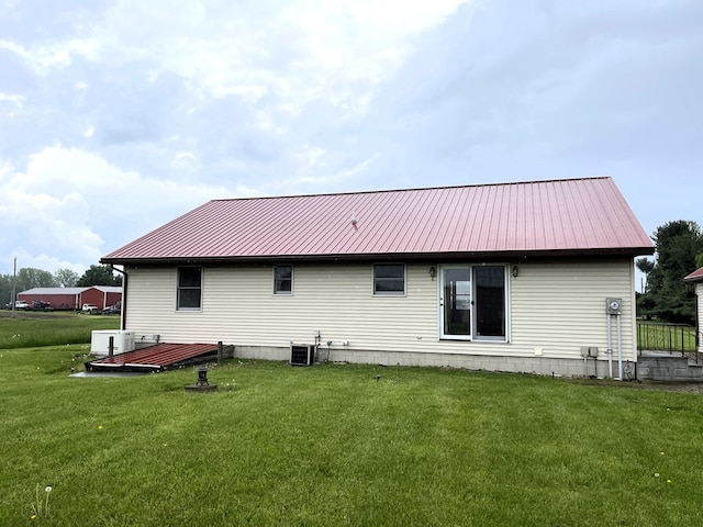 4030 Shoup Rd, Shelby, OH 44875 - rear view of house featuring metal roof, a lawn, and central AC unit