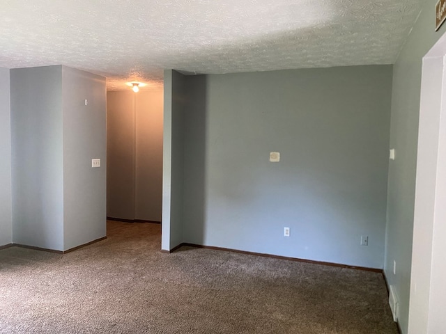 carpeted spare room featuring a textured ceiling