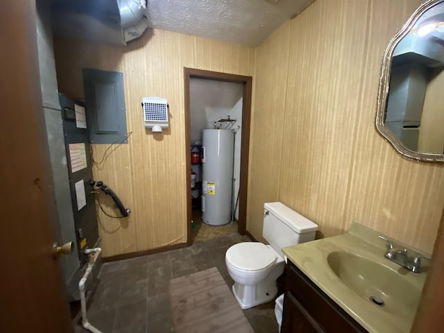 bathroom featuring a textured ceiling, water heater, vanity, toilet, and electric panel