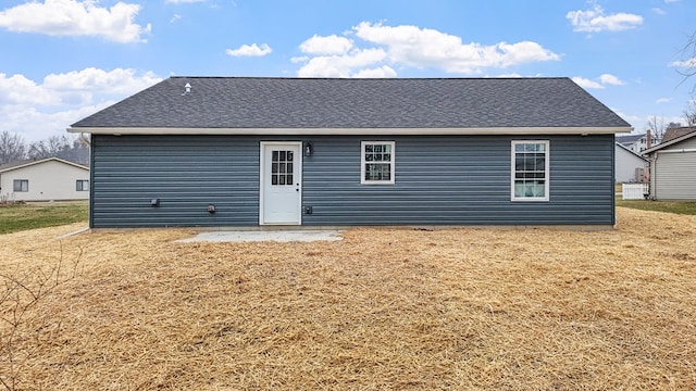 rear view of house with a yard