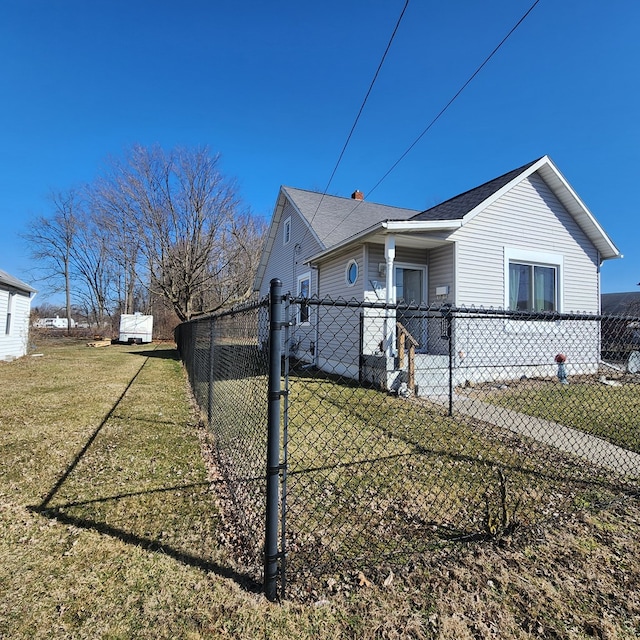 view of property exterior with a fenced front yard and a yard