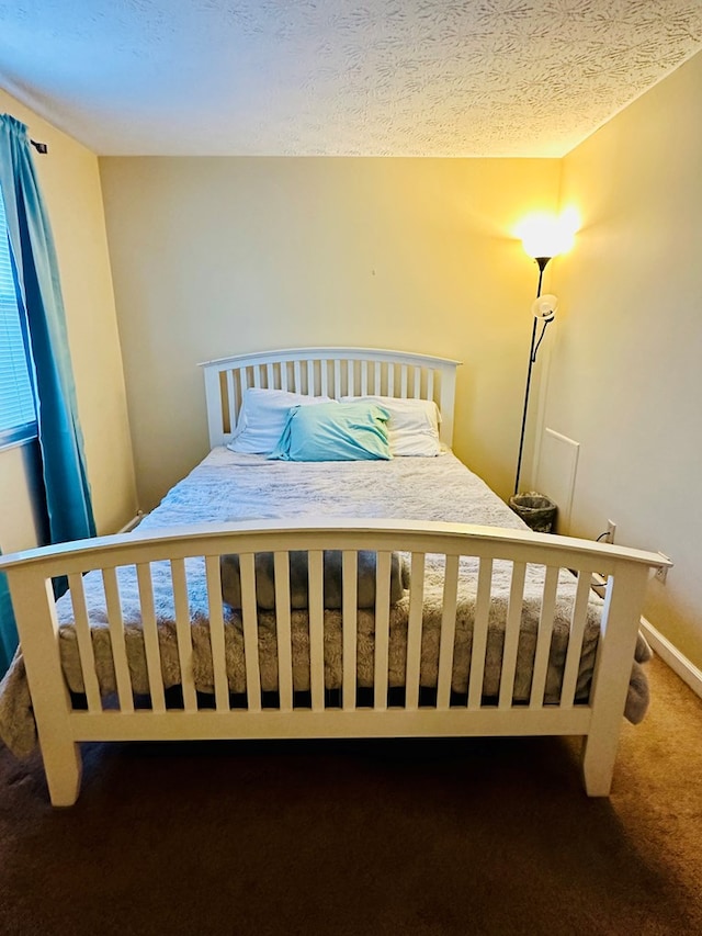 bedroom with carpet and a textured ceiling