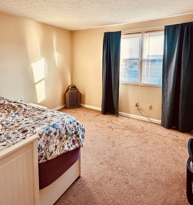 carpeted bedroom featuring a textured ceiling