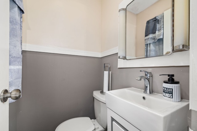 bathroom featuring vanity and toilet