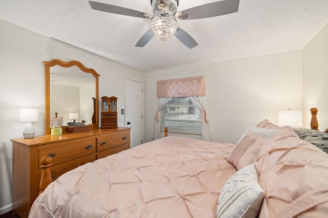 bedroom with a textured ceiling and ceiling fan