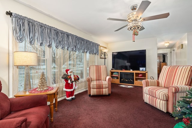 living room featuring ceiling fan and dark colored carpet