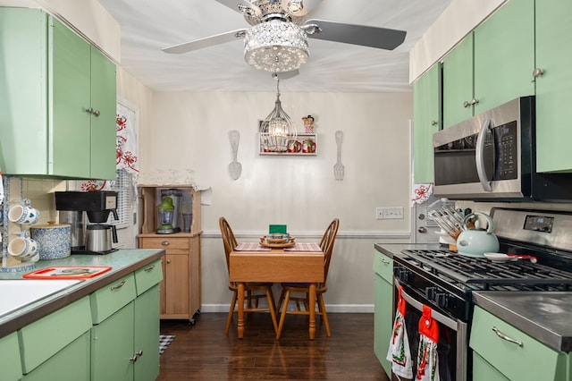 kitchen featuring green cabinets, stainless steel appliances, and dark hardwood / wood-style floors