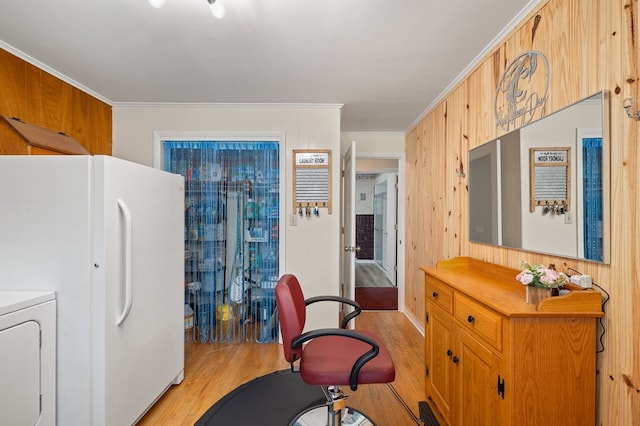 home office featuring light hardwood / wood-style floors, ornamental molding, and wooden walls