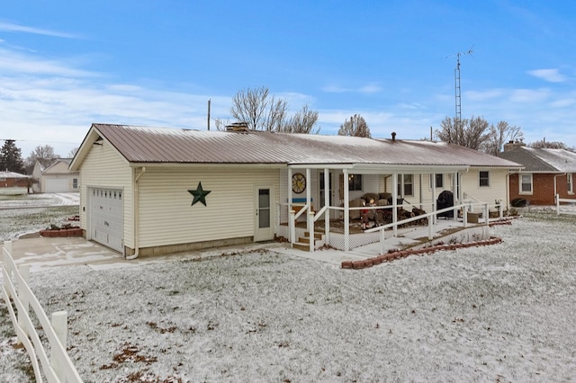 view of front of home with a porch and a garage