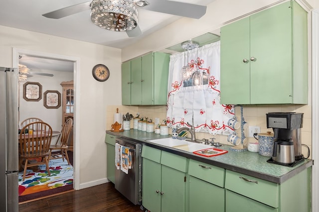 kitchen featuring sink, dark wood-type flooring, stainless steel appliances, decorative backsplash, and green cabinetry