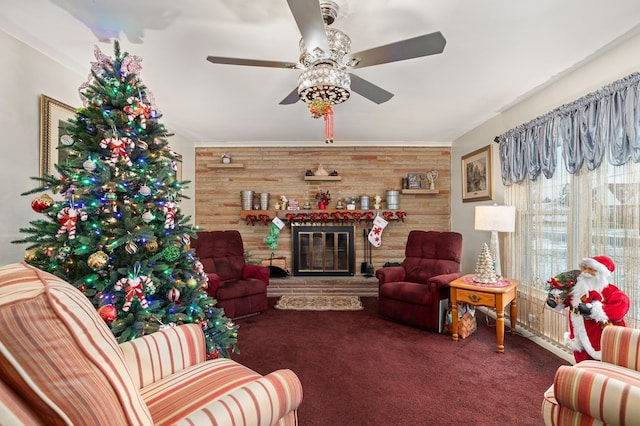 living room featuring wooden walls, ceiling fan, and dark colored carpet