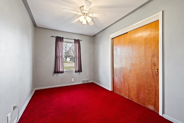 unfurnished bedroom with visible vents, baseboards, a closet, and carpet flooring