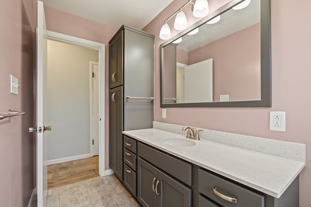 bathroom with baseboards and vanity