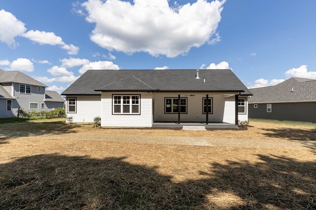 rear view of property with a lawn