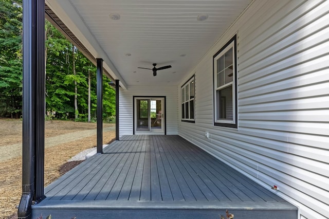 wooden terrace with ceiling fan and a porch