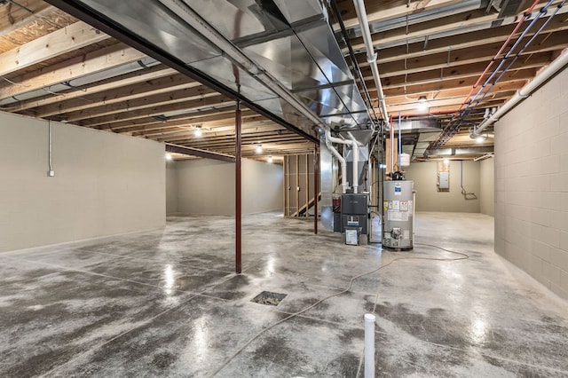 basement featuring heating unit, electric panel, and gas water heater