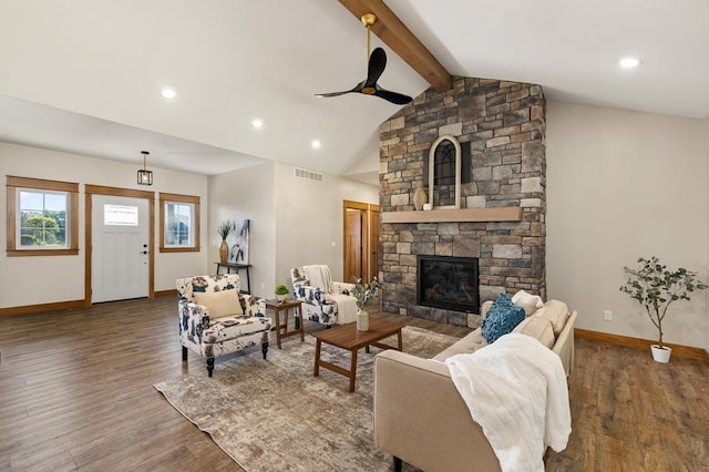 living room with a stone fireplace, ceiling fan, lofted ceiling with beams, and dark hardwood / wood-style floors