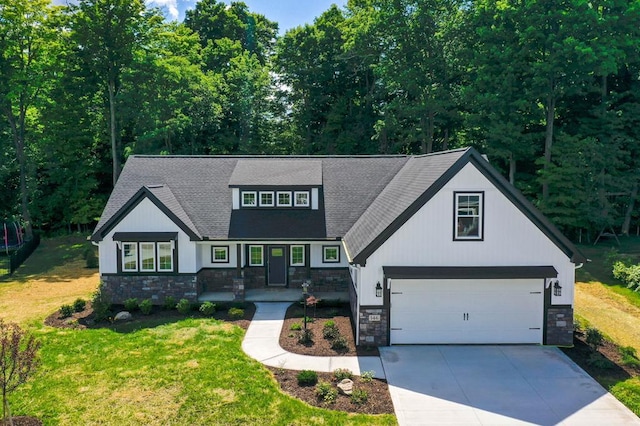 view of front of property with a front yard and a garage