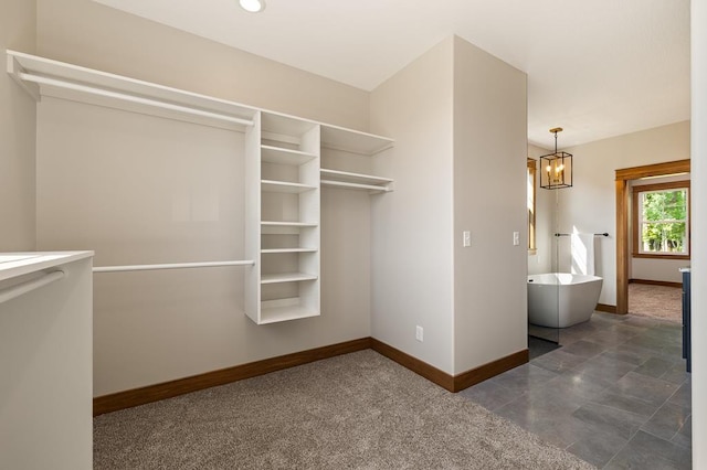 spacious closet with a notable chandelier