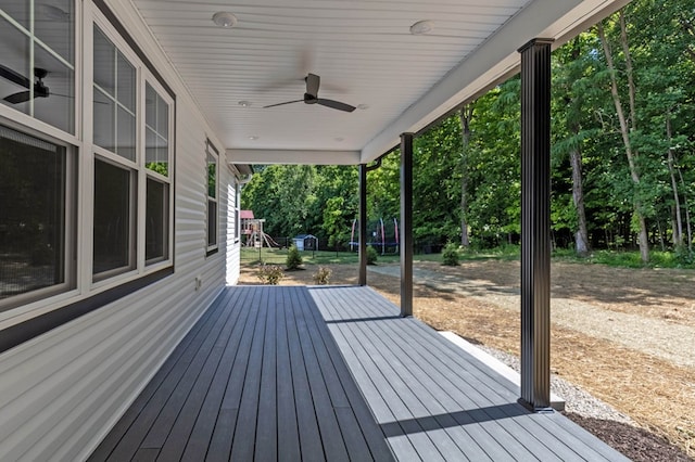 wooden deck with ceiling fan and a trampoline