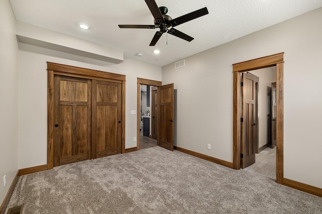 unfurnished bedroom featuring light colored carpet and ceiling fan