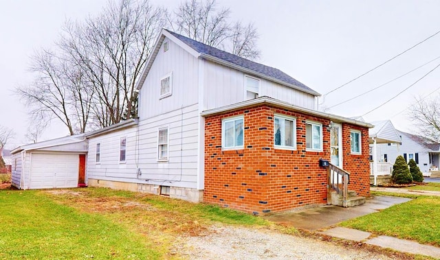 view of side of home featuring a garage and an outdoor structure