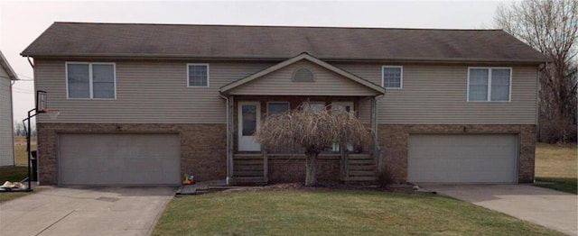 view of front of home with a garage and a front lawn