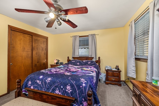 carpeted bedroom featuring a closet and ceiling fan