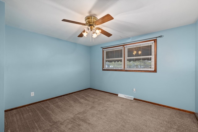 carpeted spare room with ceiling fan